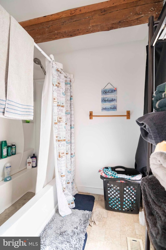 bathroom with tile flooring and shower / bath combo