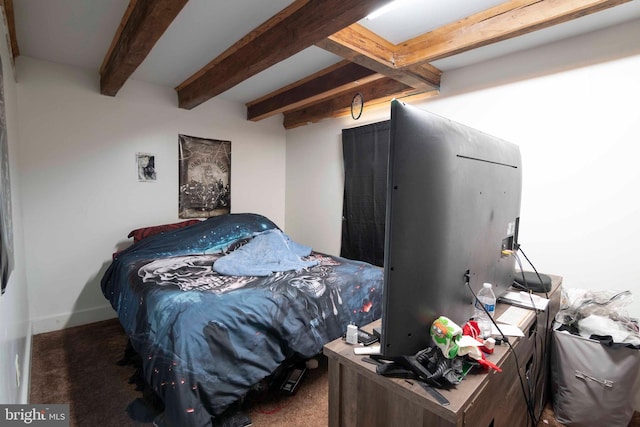 bedroom with beamed ceiling and carpet flooring