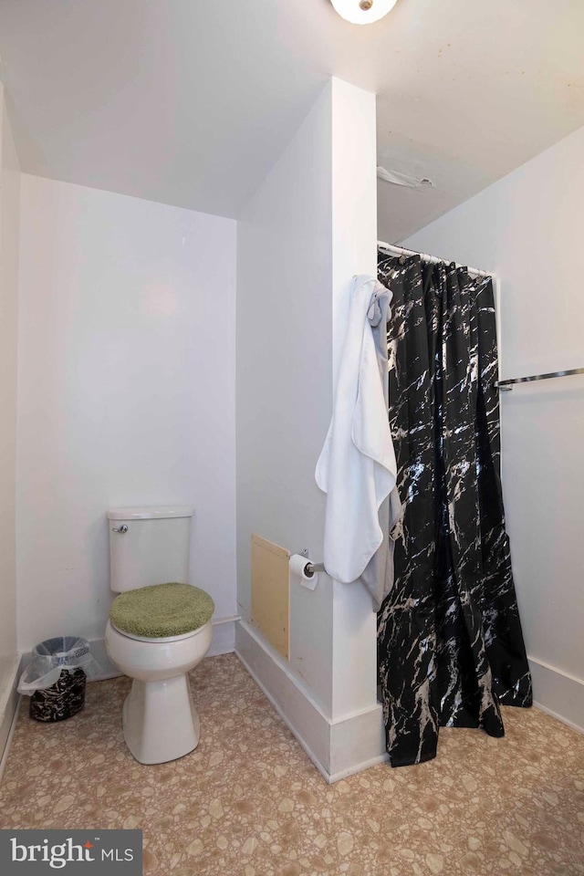 bathroom with tile flooring and toilet