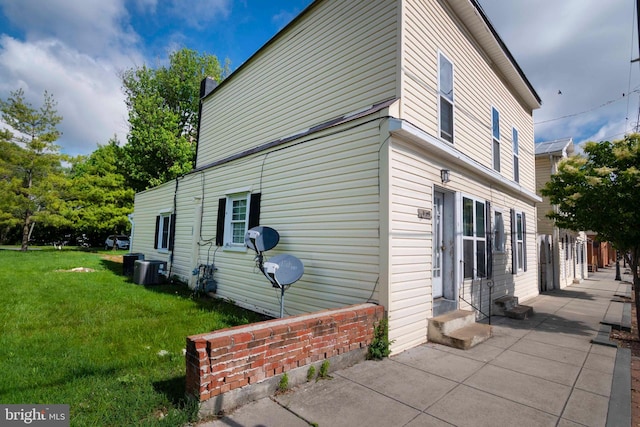 view of side of property with a lawn