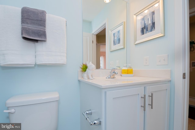 bathroom featuring toilet and large vanity