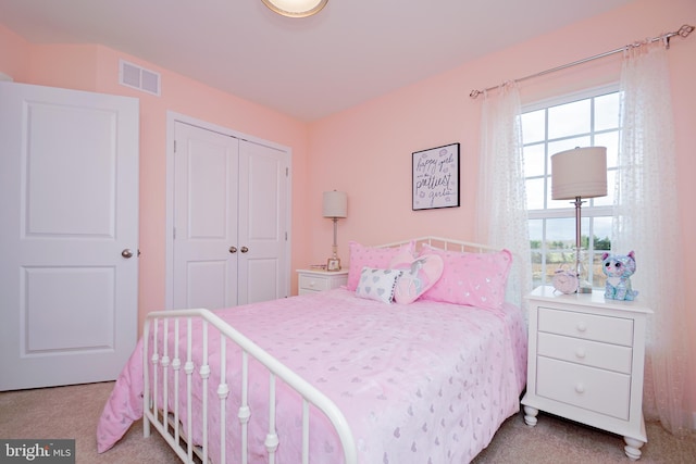 carpeted bedroom featuring a closet