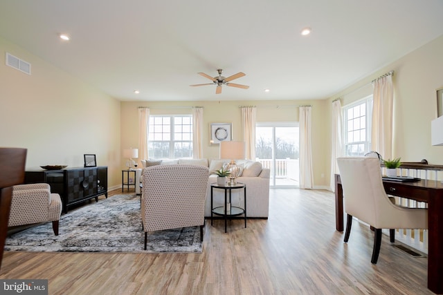 living room featuring ceiling fan and hardwood / wood-style flooring