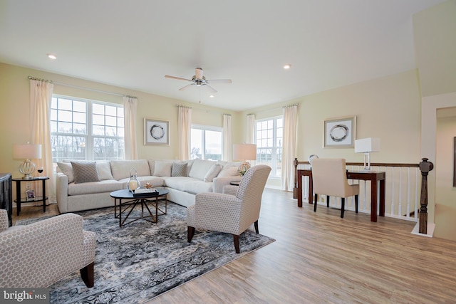 living room with hardwood / wood-style floors and ceiling fan