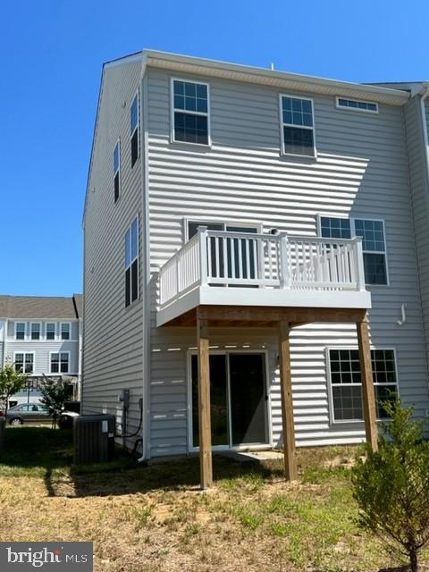 back of property featuring a deck and central air condition unit