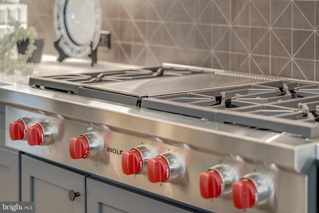 interior details featuring gray cabinetry and backsplash