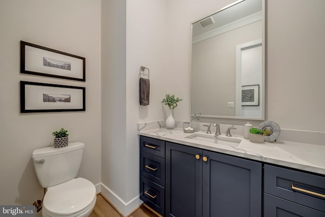 bathroom featuring hardwood / wood-style floors, oversized vanity, and toilet