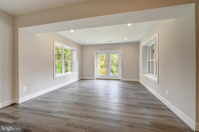 spare room featuring hardwood / wood-style flooring and french doors