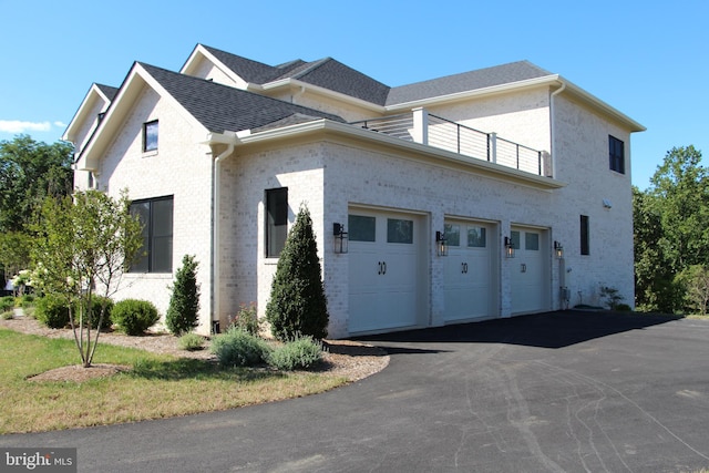 view of front of house featuring a garage and a balcony