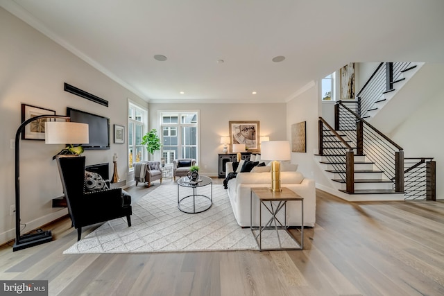 living room with light hardwood / wood-style floors and ornamental molding