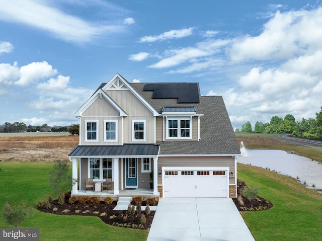 view of front of property featuring a garage, a front yard, solar panels, and a porch