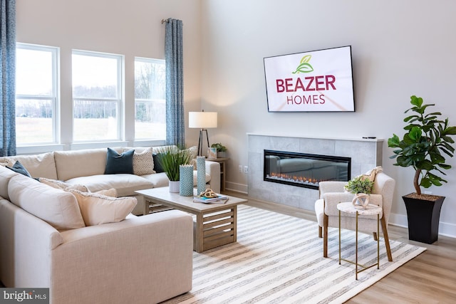 living room featuring light hardwood / wood-style floors and a tile fireplace