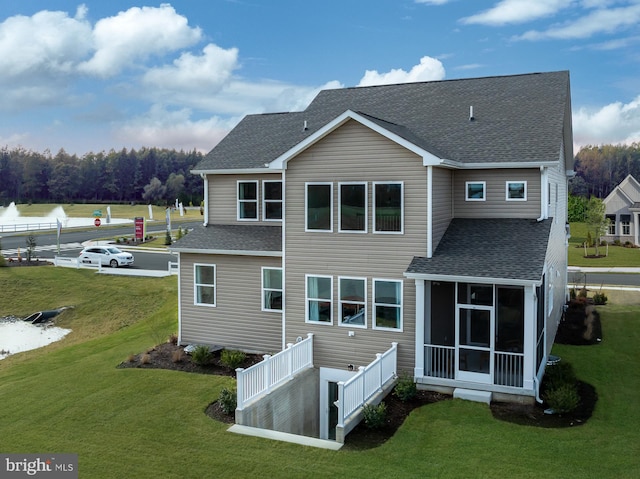 back of house featuring a sunroom and a yard