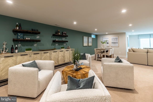 carpeted living room featuring bar area