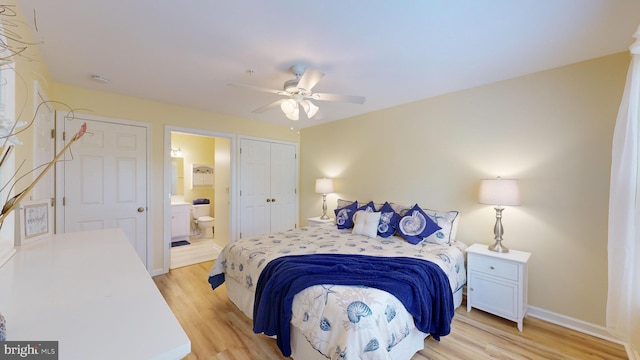 bedroom featuring light hardwood / wood-style floors, ensuite bath, and ceiling fan