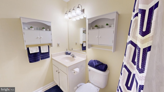 bathroom featuring vanity and toilet