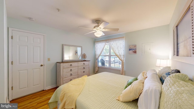 bedroom with light hardwood / wood-style floors and ceiling fan