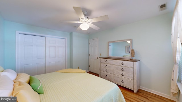 bedroom featuring ceiling fan, a closet, and light hardwood / wood-style flooring