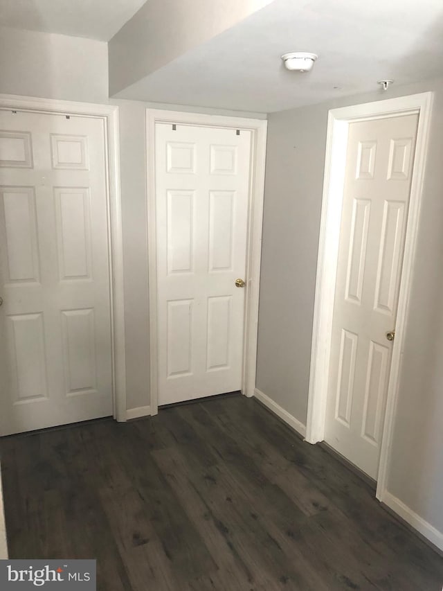 hallway with dark hardwood / wood-style floors