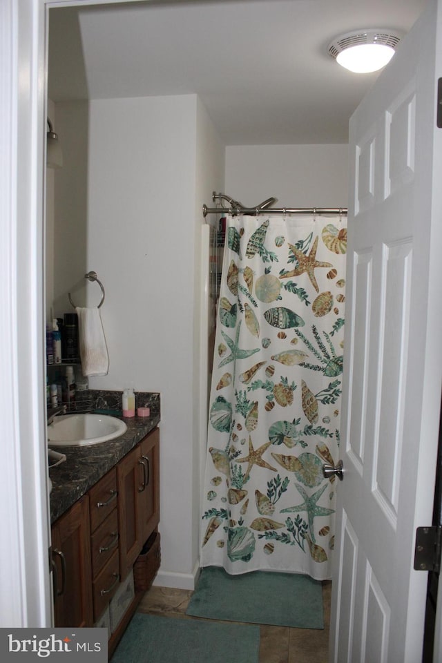 bathroom with tile flooring and vanity