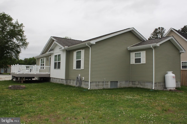 view of home's exterior featuring a deck and a lawn