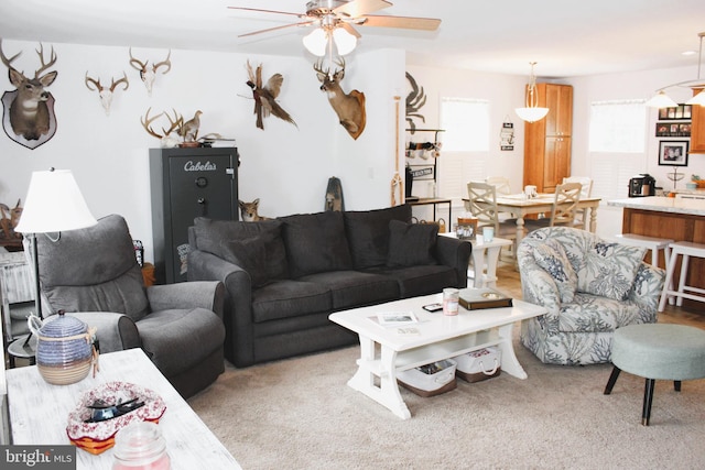 carpeted living room featuring ceiling fan