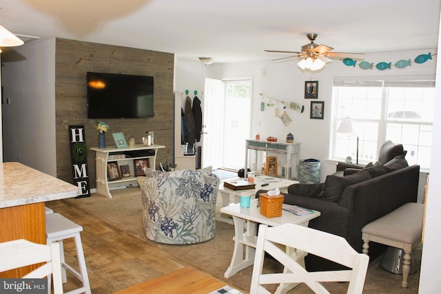 living room featuring wood-type flooring and ceiling fan