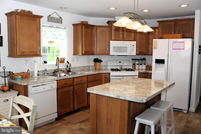 kitchen with a kitchen island, dark hardwood / wood-style flooring, white appliances, decorative light fixtures, and sink