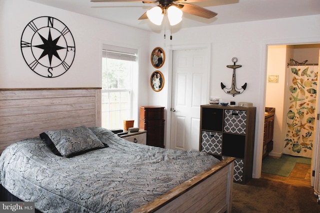 carpeted bedroom featuring ceiling fan and ensuite bath