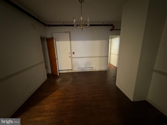 unfurnished dining area with a baseboard heating unit, dark hardwood / wood-style flooring, and an inviting chandelier