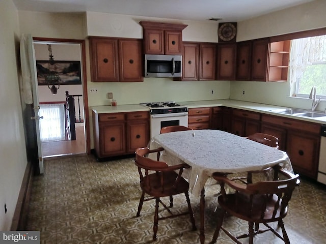 kitchen featuring sink and white appliances