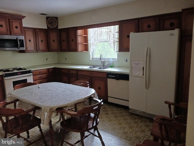 kitchen featuring white appliances and sink