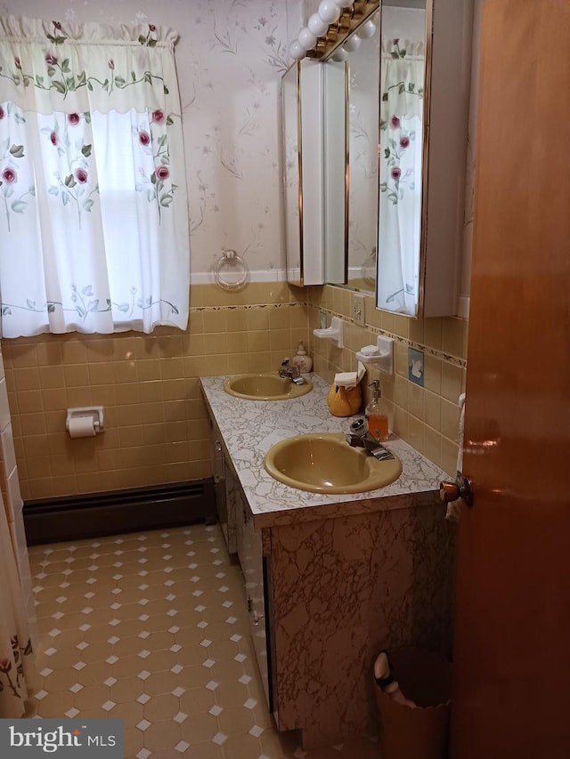 bathroom with vanity, tile walls, and a baseboard heating unit