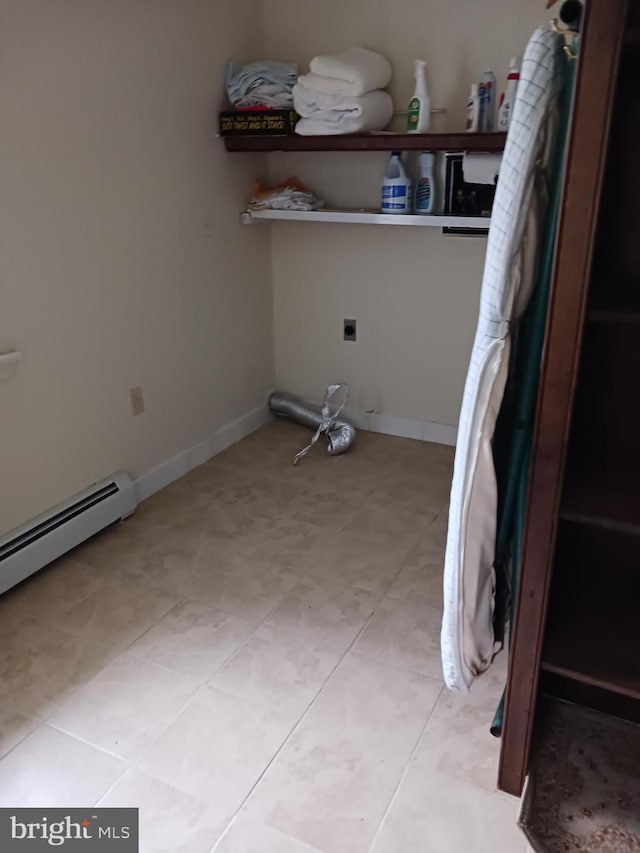 clothes washing area with hookup for an electric dryer and baseboard heating