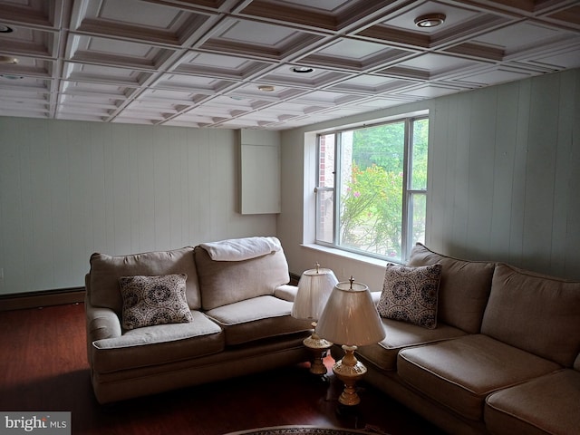 living room with hardwood / wood-style flooring, wooden walls, and coffered ceiling