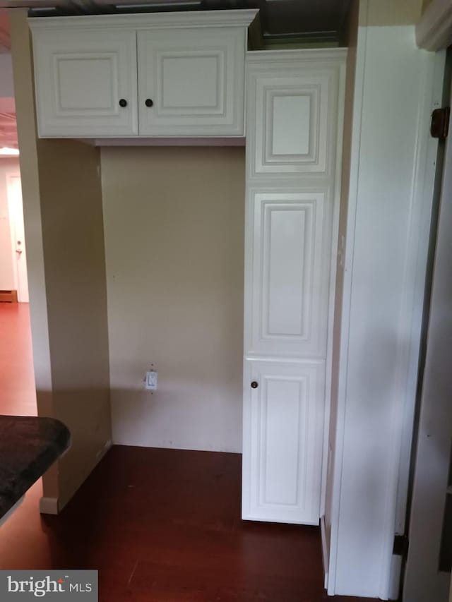 kitchen with white cabinetry and dark hardwood / wood-style floors