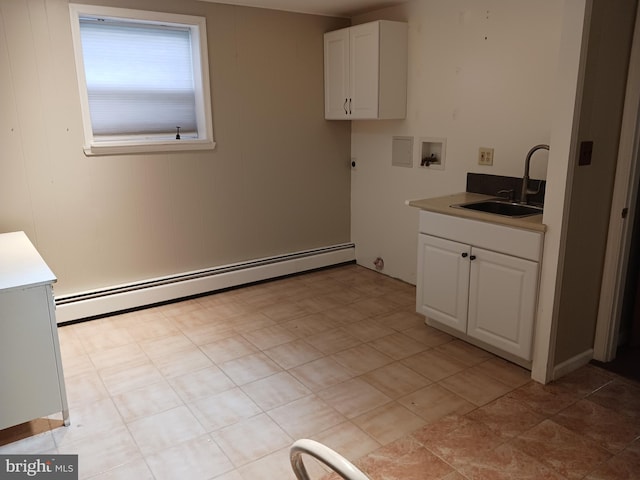 clothes washing area featuring sink, cabinets, hookup for a gas dryer, a baseboard heating unit, and hookup for a washing machine