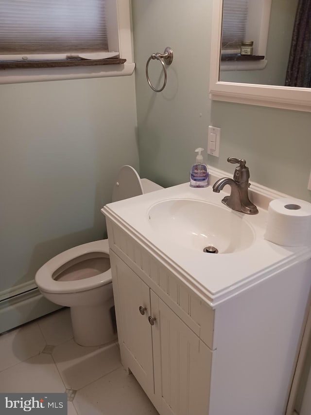 bathroom with tile patterned flooring, vanity, and toilet