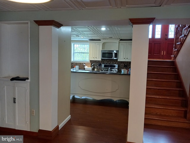 kitchen featuring decorative backsplash, dark hardwood / wood-style flooring, sink, and appliances with stainless steel finishes