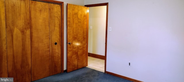 unfurnished bedroom featuring light tile patterned flooring and a closet