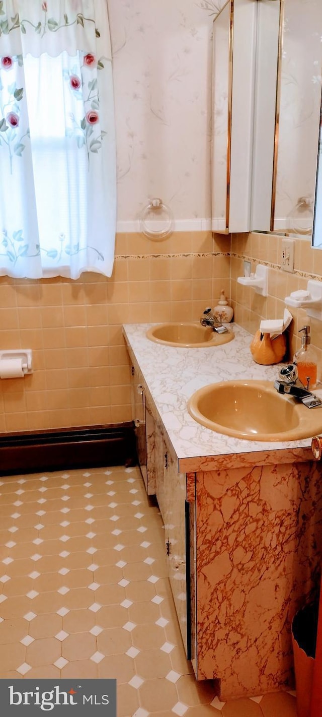 bathroom with vanity and tile walls