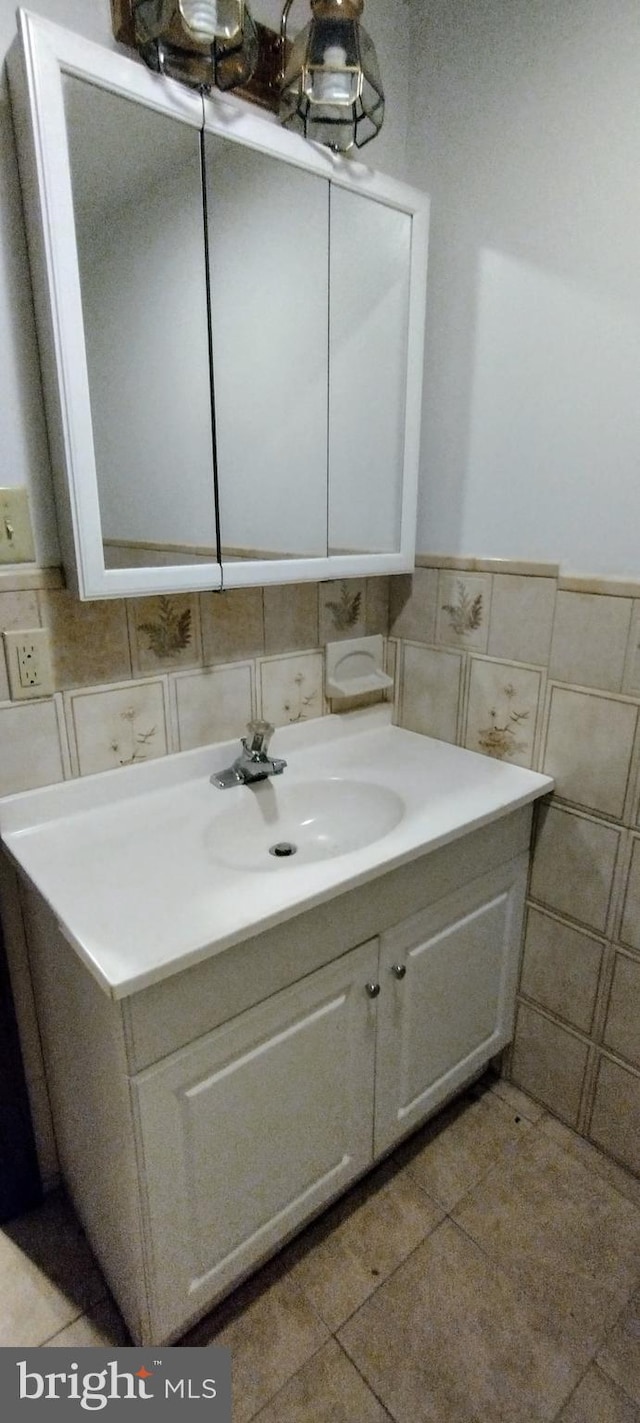 bathroom featuring tile patterned floors, vanity, and tile walls