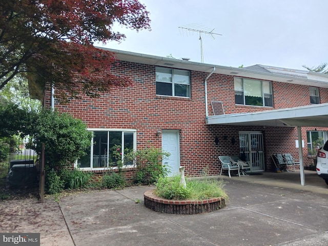 back of property featuring a carport