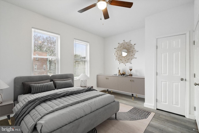 bedroom with ceiling fan and wood-type flooring