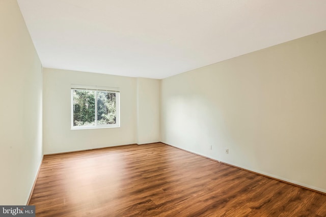 unfurnished room with hardwood / wood-style flooring