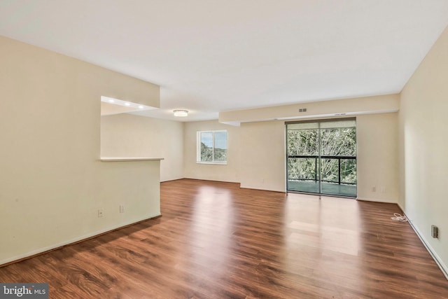 unfurnished room featuring dark wood-type flooring