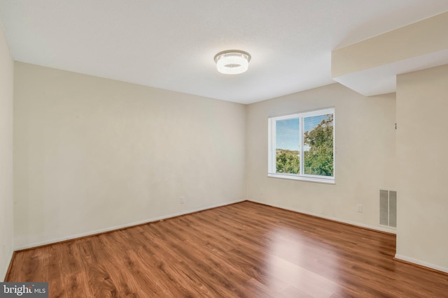 unfurnished room featuring hardwood / wood-style floors