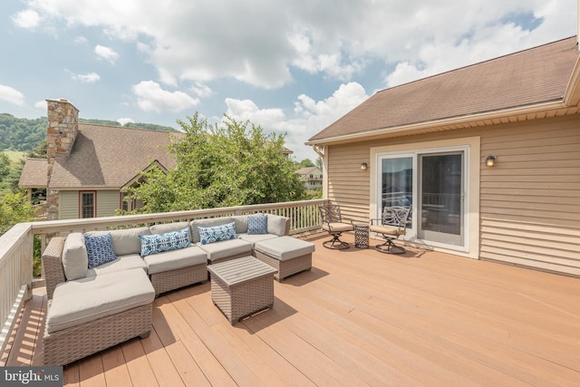 wooden terrace featuring outdoor lounge area