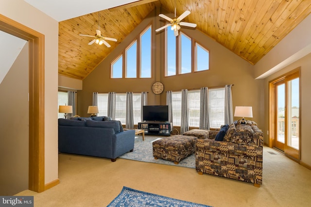 carpeted living room with high vaulted ceiling, plenty of natural light, and ceiling fan