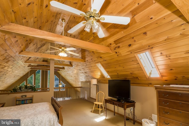 bedroom with carpet flooring, lofted ceiling with skylight, and wood ceiling